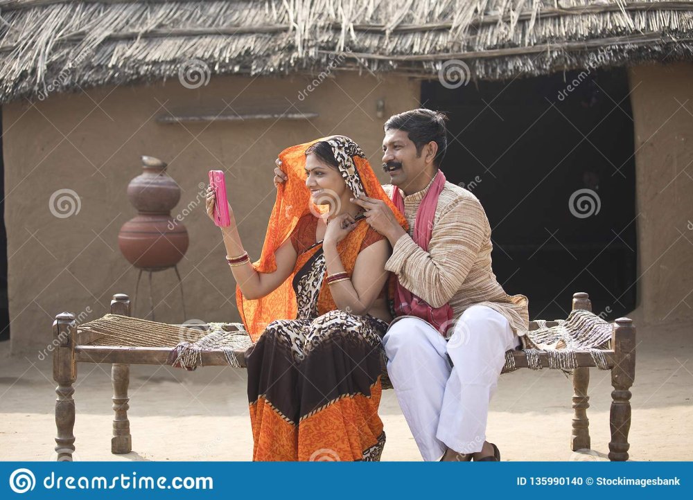 rural-indian-couple-looking-mirror-sitting-traditional-bed-village-rural-couple-looking-mirror-village-135990140.jpg